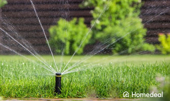 Impianto di irrigazione interrato con irrigatore a scomparsa che bagna uniformemente il prato verde in giardino - Homedeal
